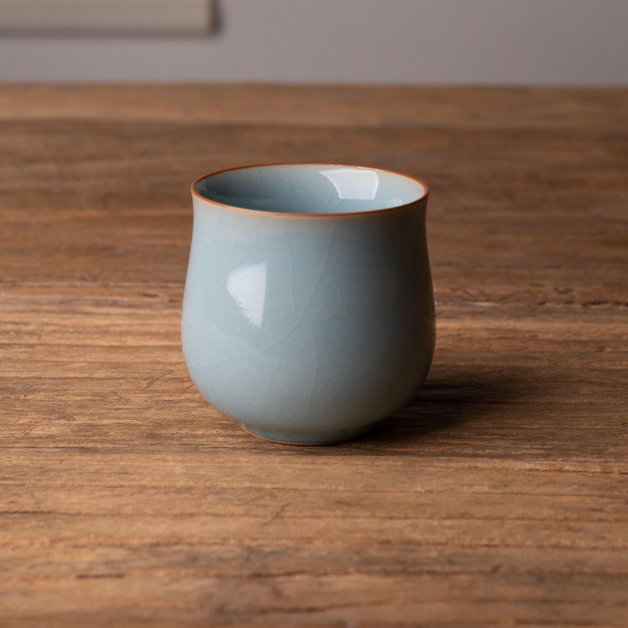 Celadon glaze tea cup in serene sky after rain color